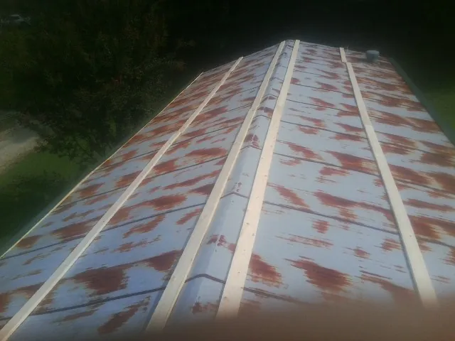 Rusted metal roof panels with new wood purlins before replacement — Storm Damage Roof Repair in Parkesburg by Roofing Brothers