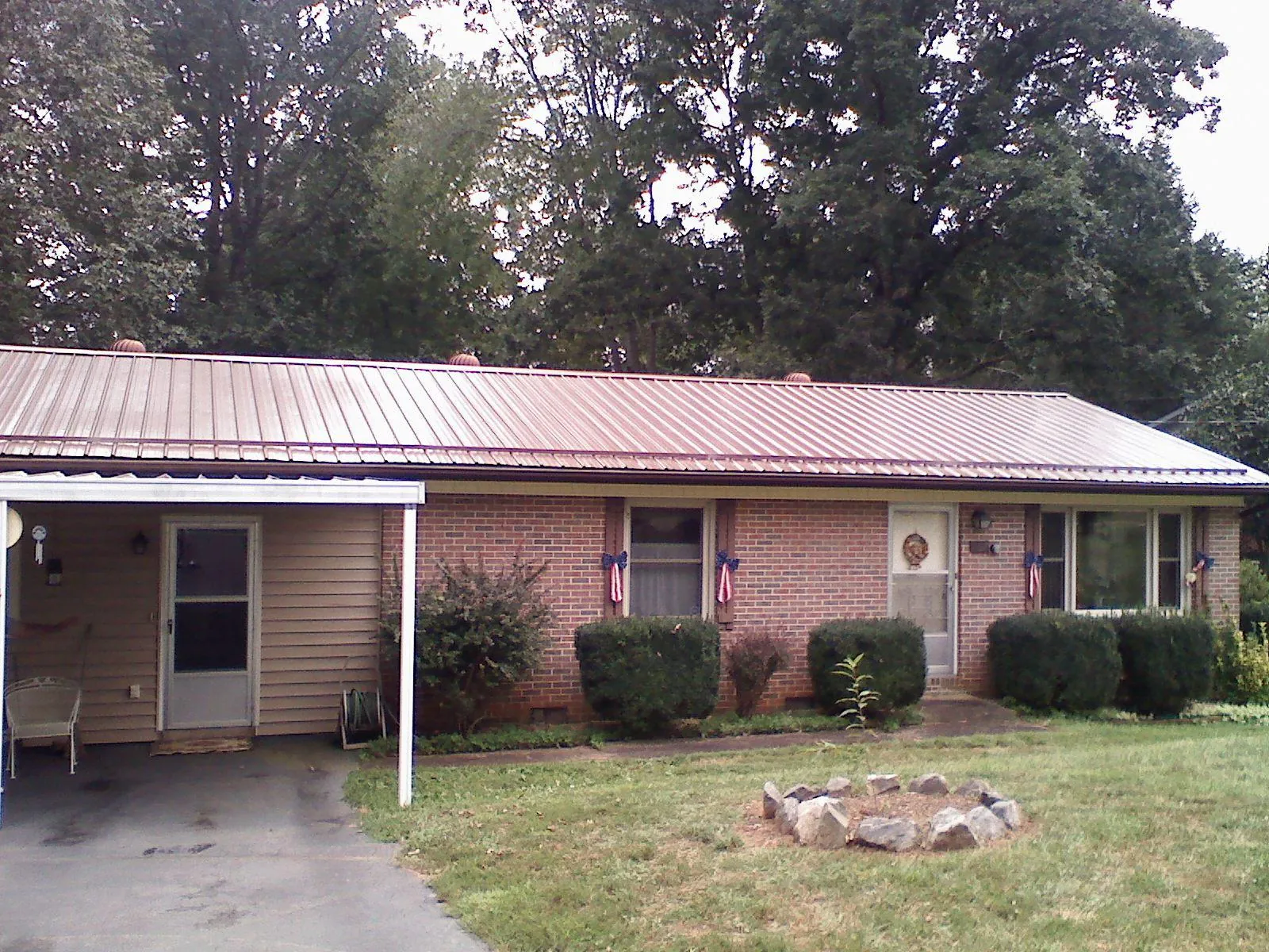 Bronze metal roof and carport on a brick ranch home — Roof Repair work by our crew in Parkesburg
